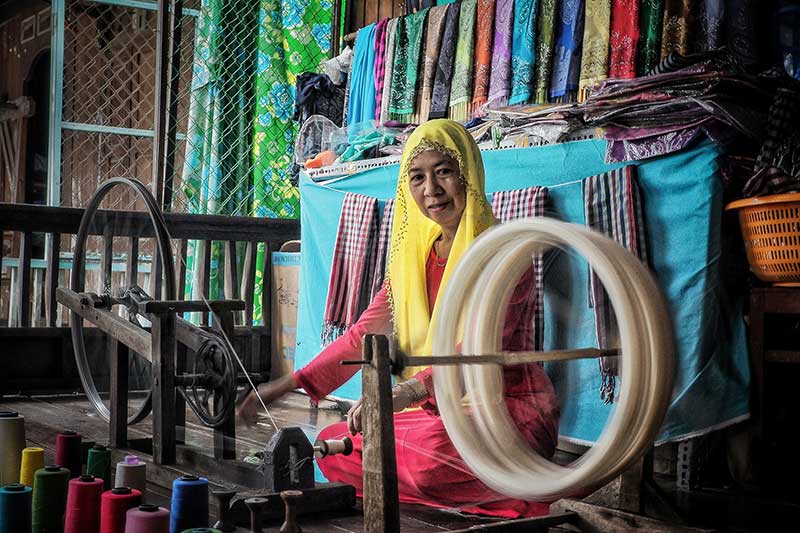A Cham woman does weaving 