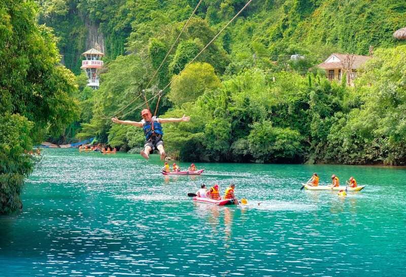Giant zipline over rainforest and emerald blue river 