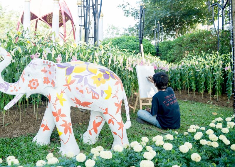 a boy paints in the garden