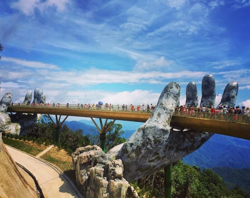 Side view of the Golden Bridge Da Nang with crowds enjoying panoramic views
