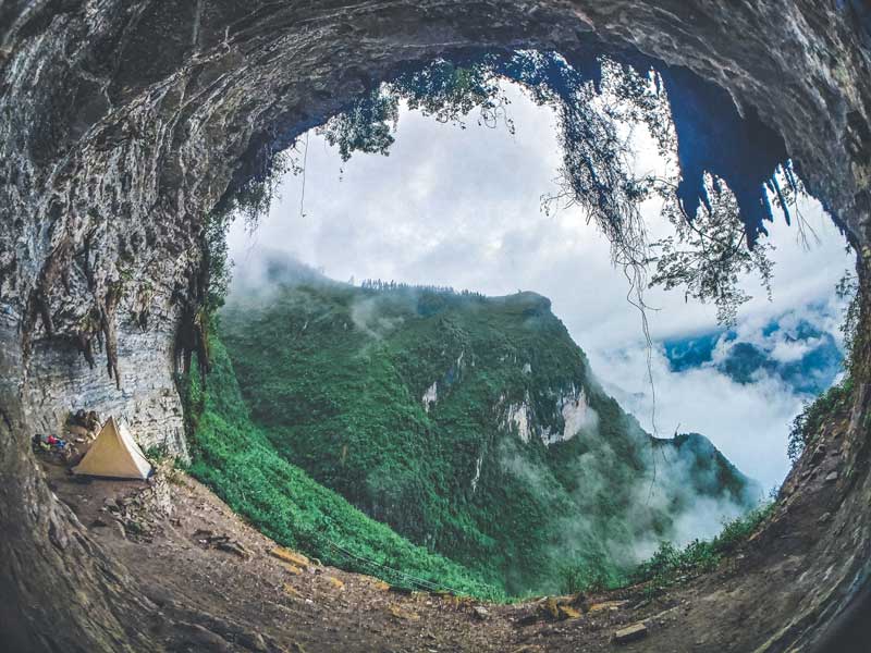 Camping in a cave overlooking misty mountains in Ha Giang Loop Vietnam