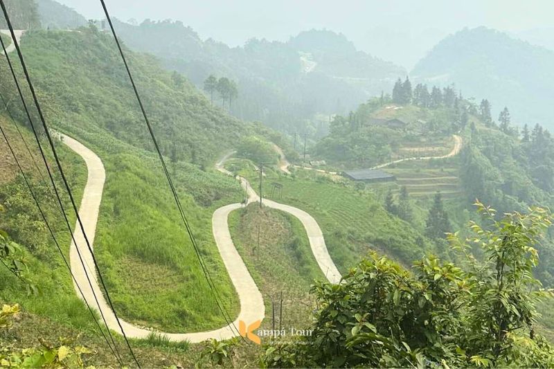 Winding mountain road near Quan Ba on the Ha Giang Loop Vietnam surrounded by lush greenery