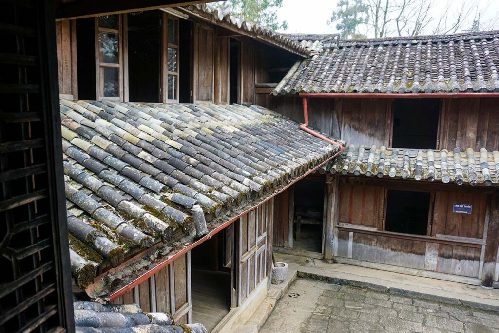 Traditional wooden architecture and tiled roof of the Hmong King Palace in Ha Giang Loop Vietnam
