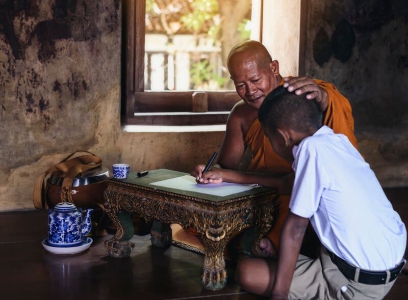 It is not recommended to touch someone's head unless you are a monk