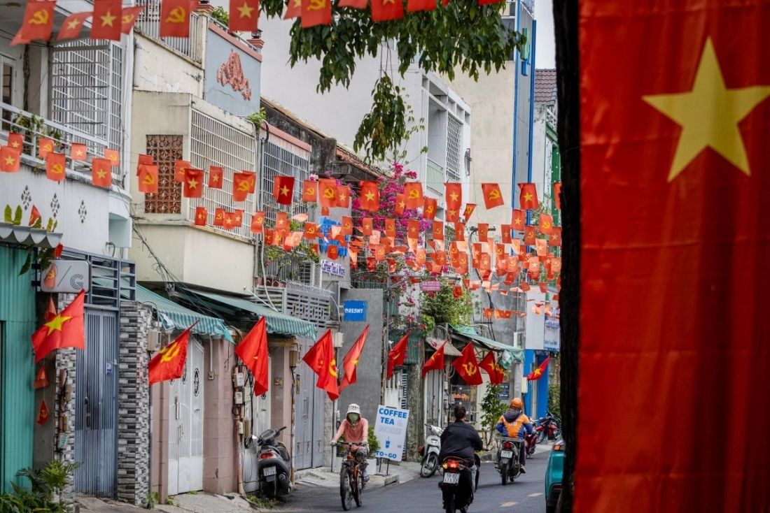 The streets of Ho Chi Minh City burst with color from the flags.